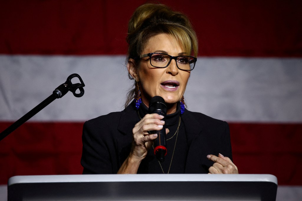 Sarah Palin, Republican candidate for the U.S. House of Representatives, speaks into a microphone at a campaign event in Anchorage, Alaska on October 9, 2022.